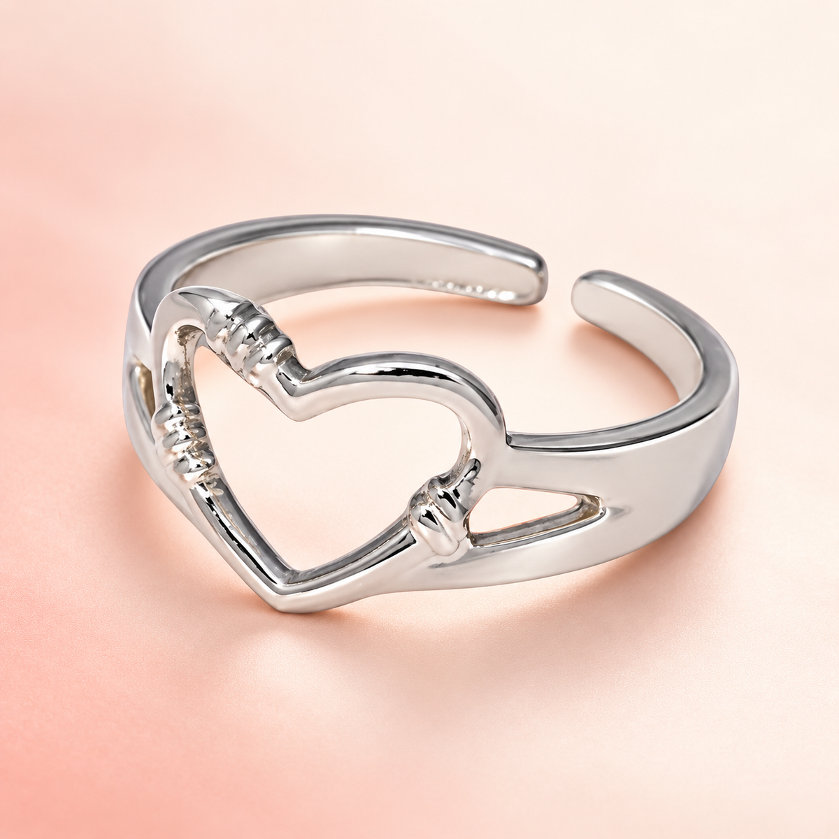 Silver-Tone Open Heart Ring on a softly coloured surface