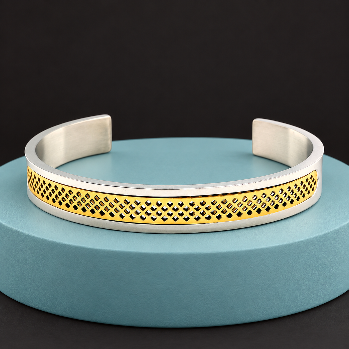 Two-tone lattice cuff displayed on an aqua plinth