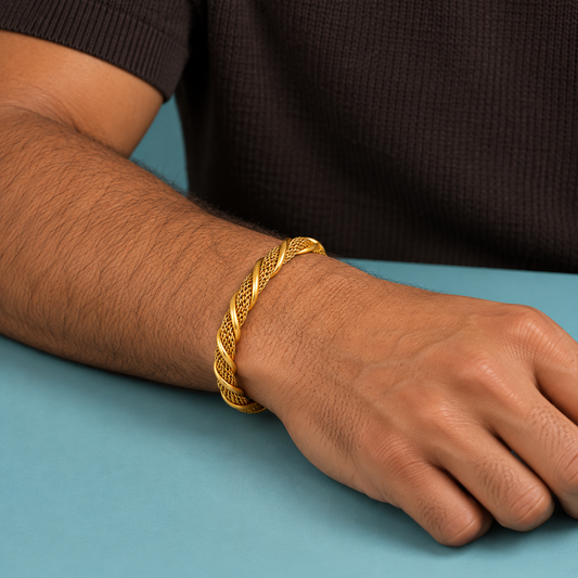 Gold-tone twisted mesh cuff styled on a wrist