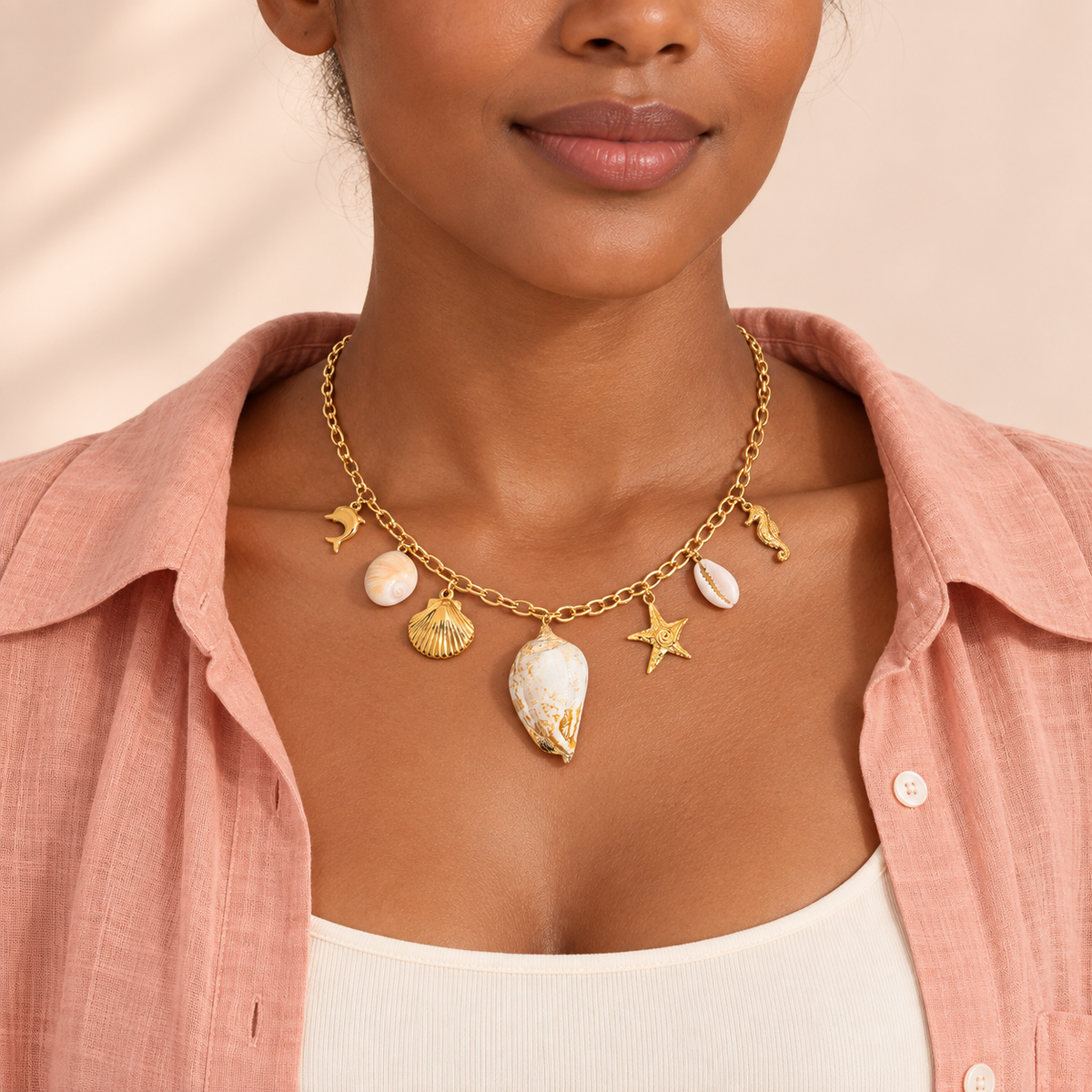 Gold-tone necklace with seven marine-themed charms