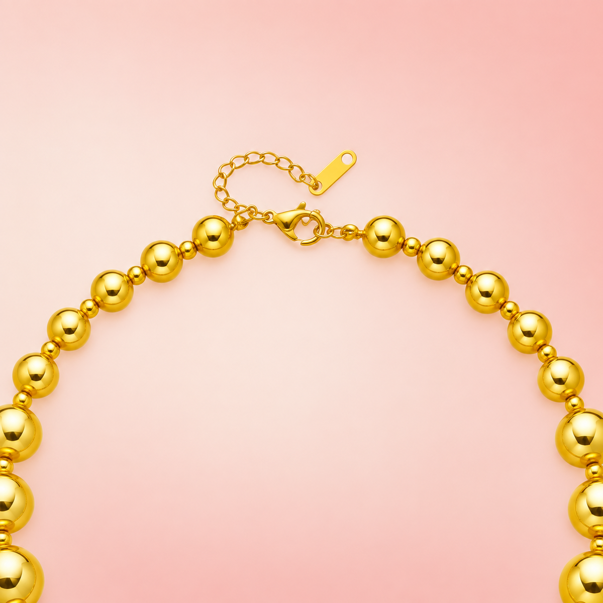 Gold-tone necklace with graduated round beads and small spacers