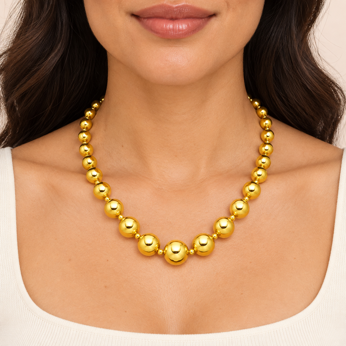 Gold-tone necklace with graduated round beads and small spacers