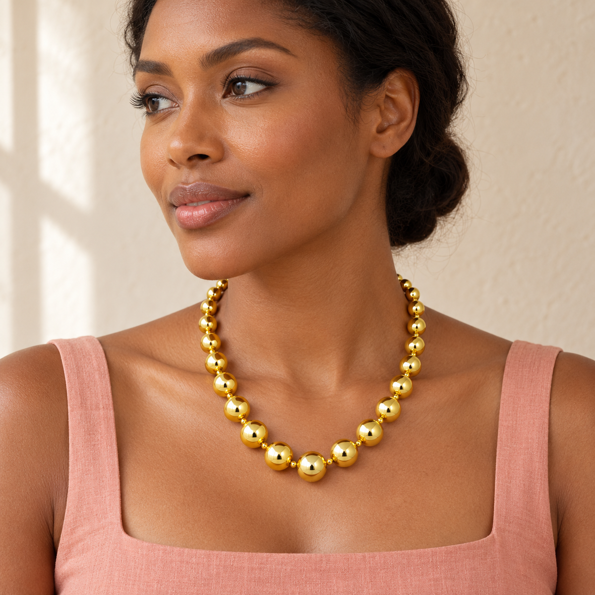 Gold-tone necklace with graduated round beads and small spacers