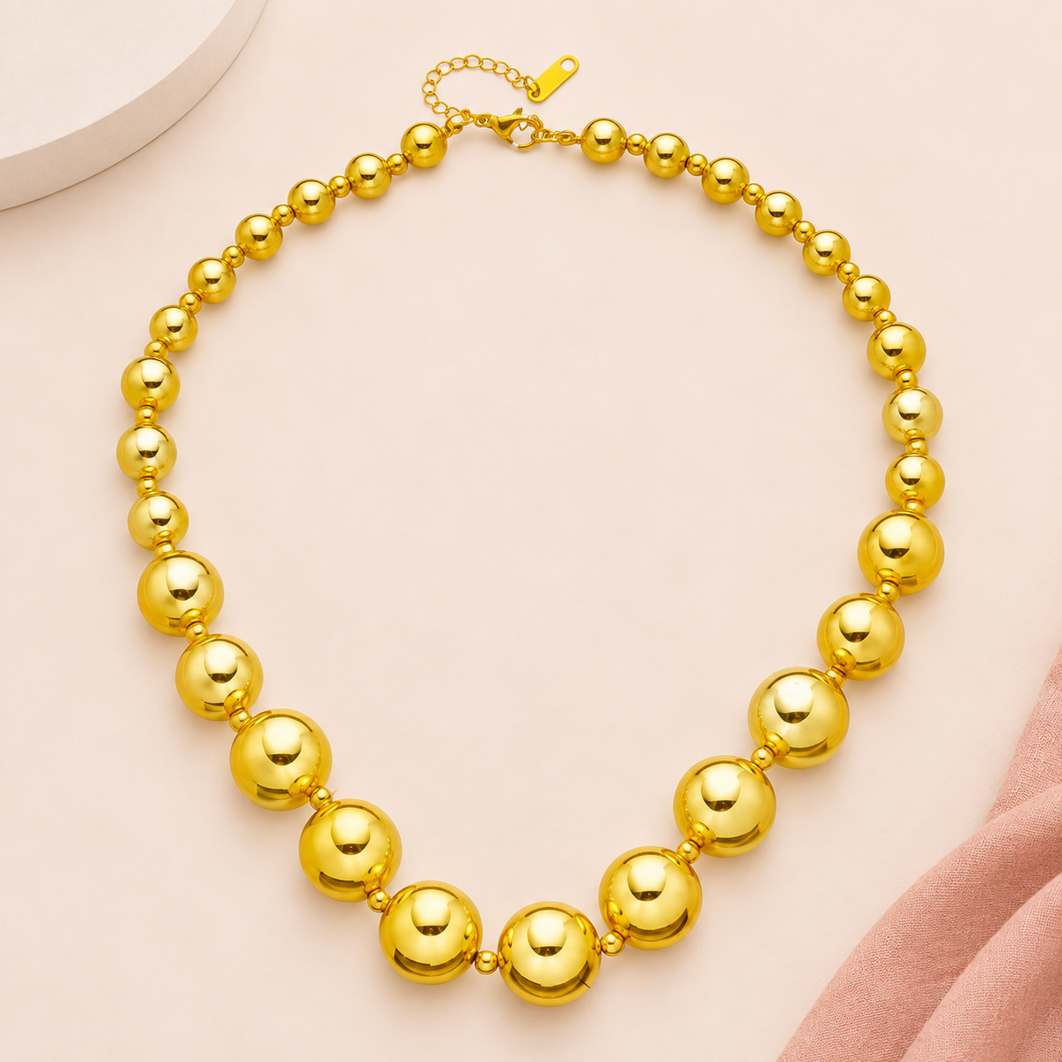 Gold-tone necklace with graduated round beads and small spacers