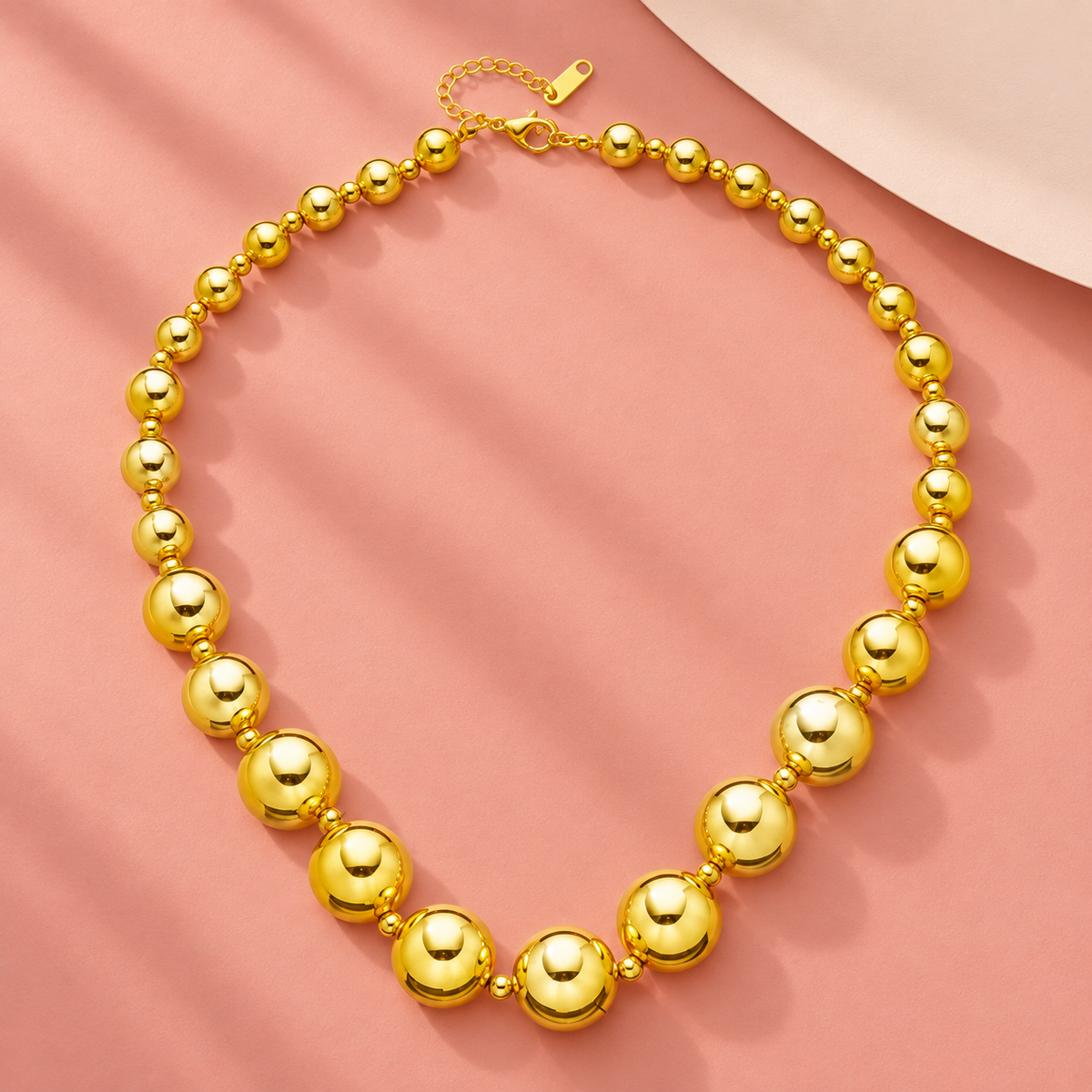 Gold-tone necklace with graduated round beads and small spacers