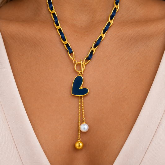 Navy ribbon-weave necklace with gold-tone links, heart-shaped drop and two bead-ended tails
