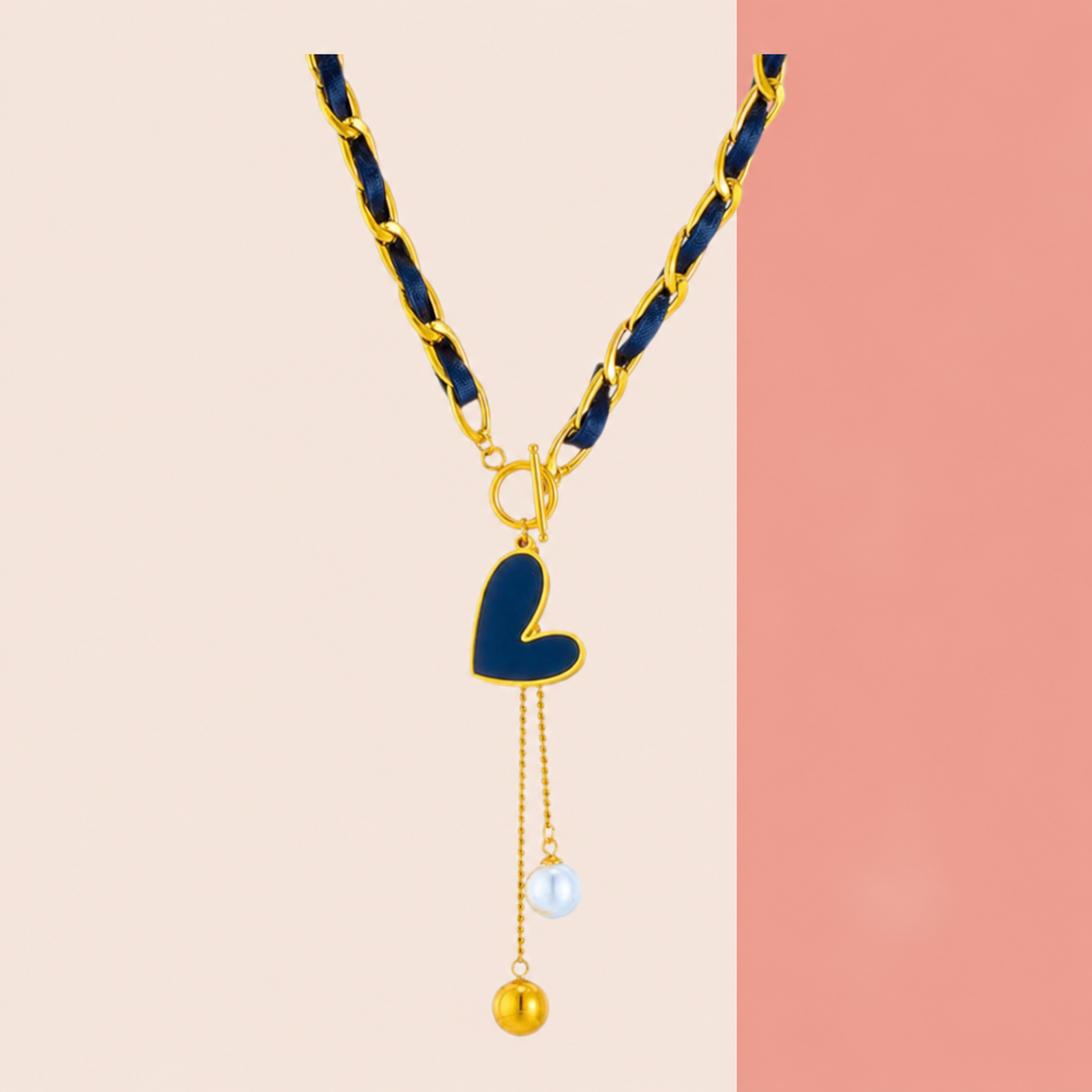 Navy ribbon-weave necklace with gold-tone links, heart-shaped drop and two bead-ended tails