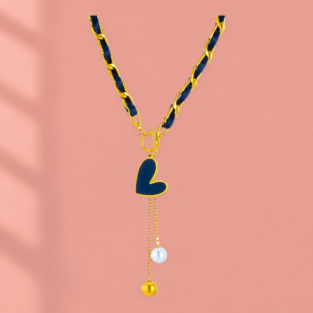 Navy ribbon-weave necklace with gold-tone links, heart-shaped drop and two bead-ended tails