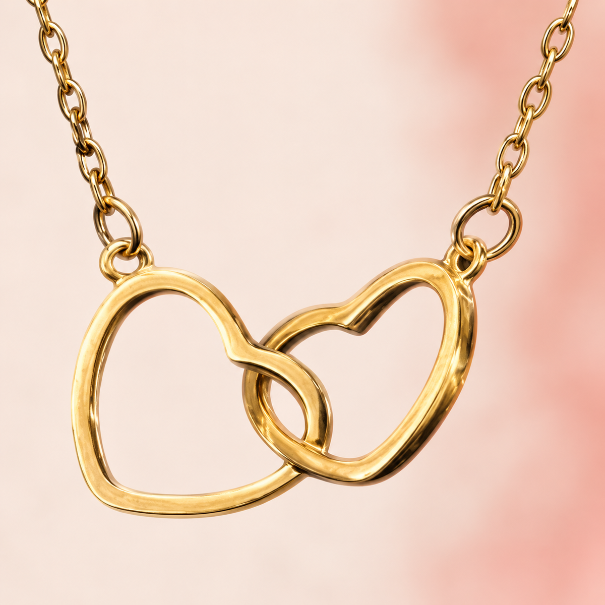 Gold-tone fine-chain necklace with two interlinked open hearts