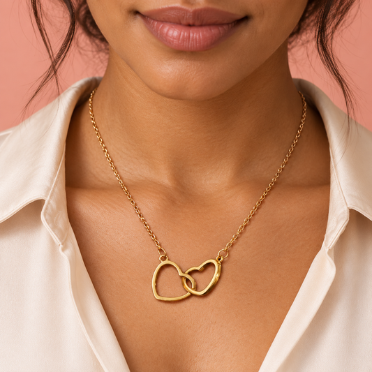 Gold-tone fine-chain necklace with two interlinked open hearts
