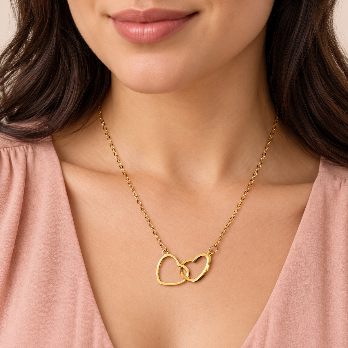 Gold-tone fine-chain necklace with two interlinked open hearts