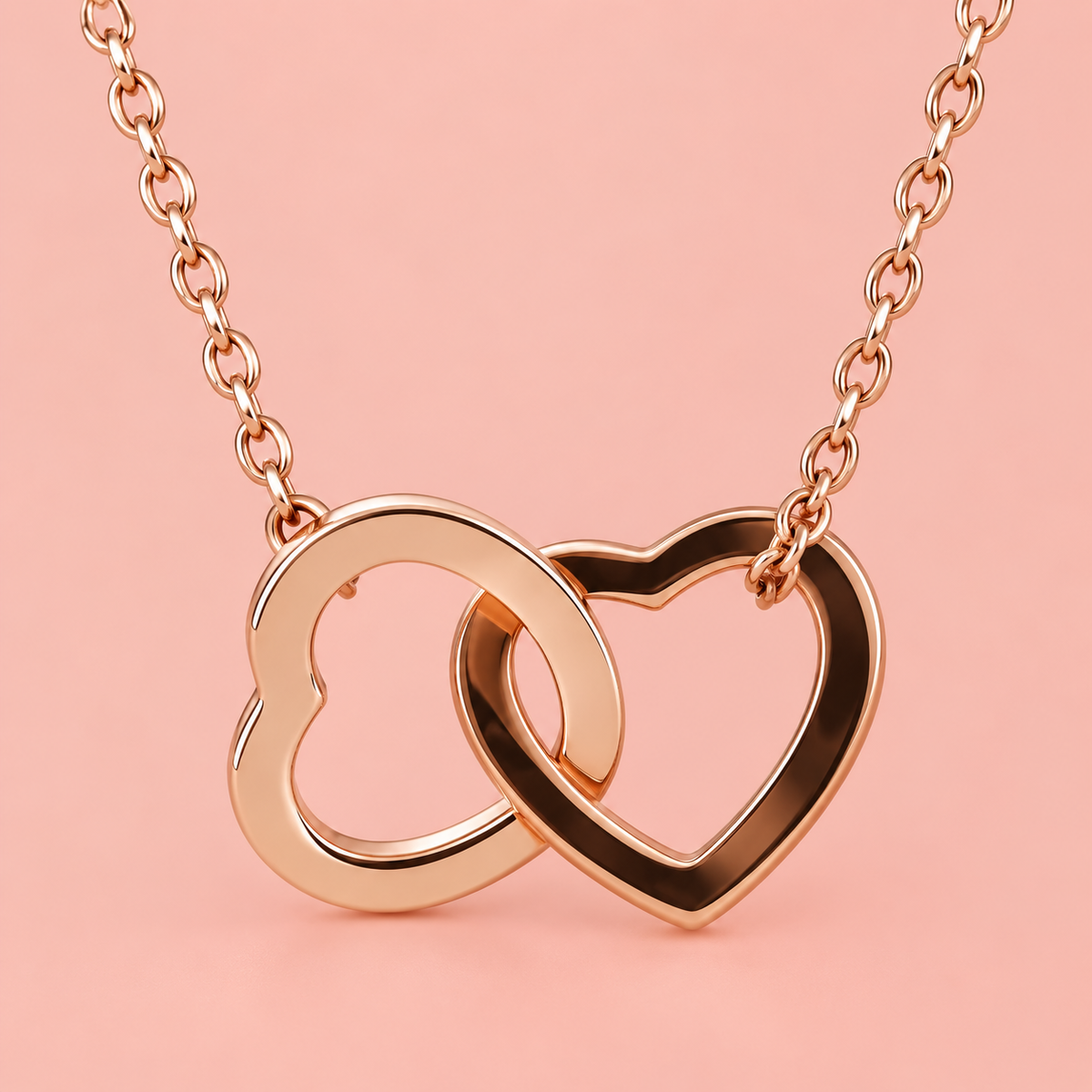 Rose-gold-tone necklace with two interlinked open heart shapes