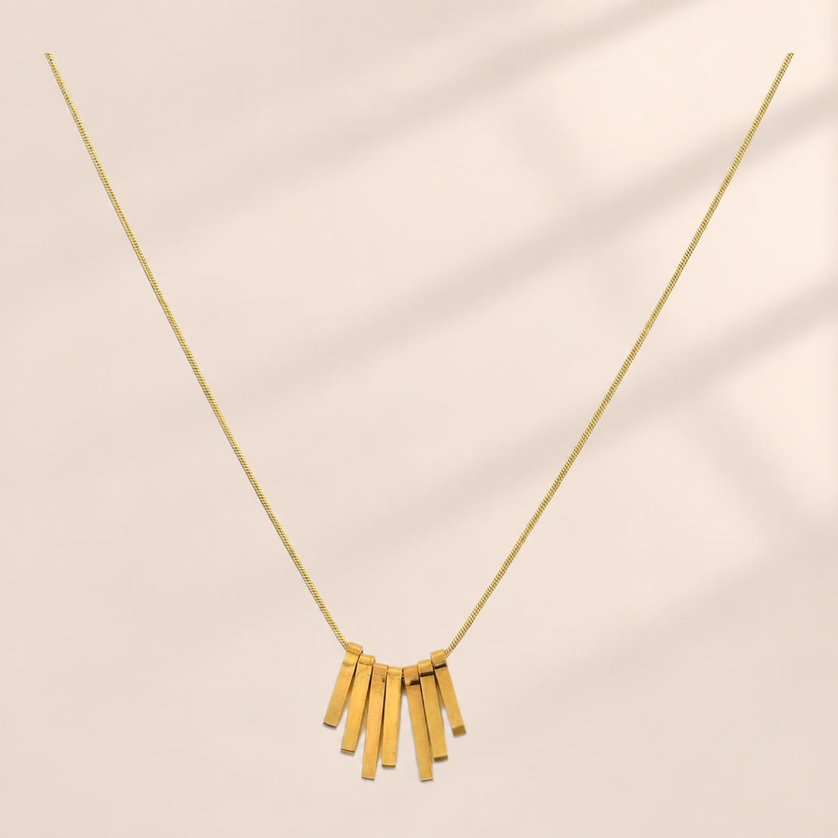Gold-tone fine-chain necklace with seven graduated rectangular drops