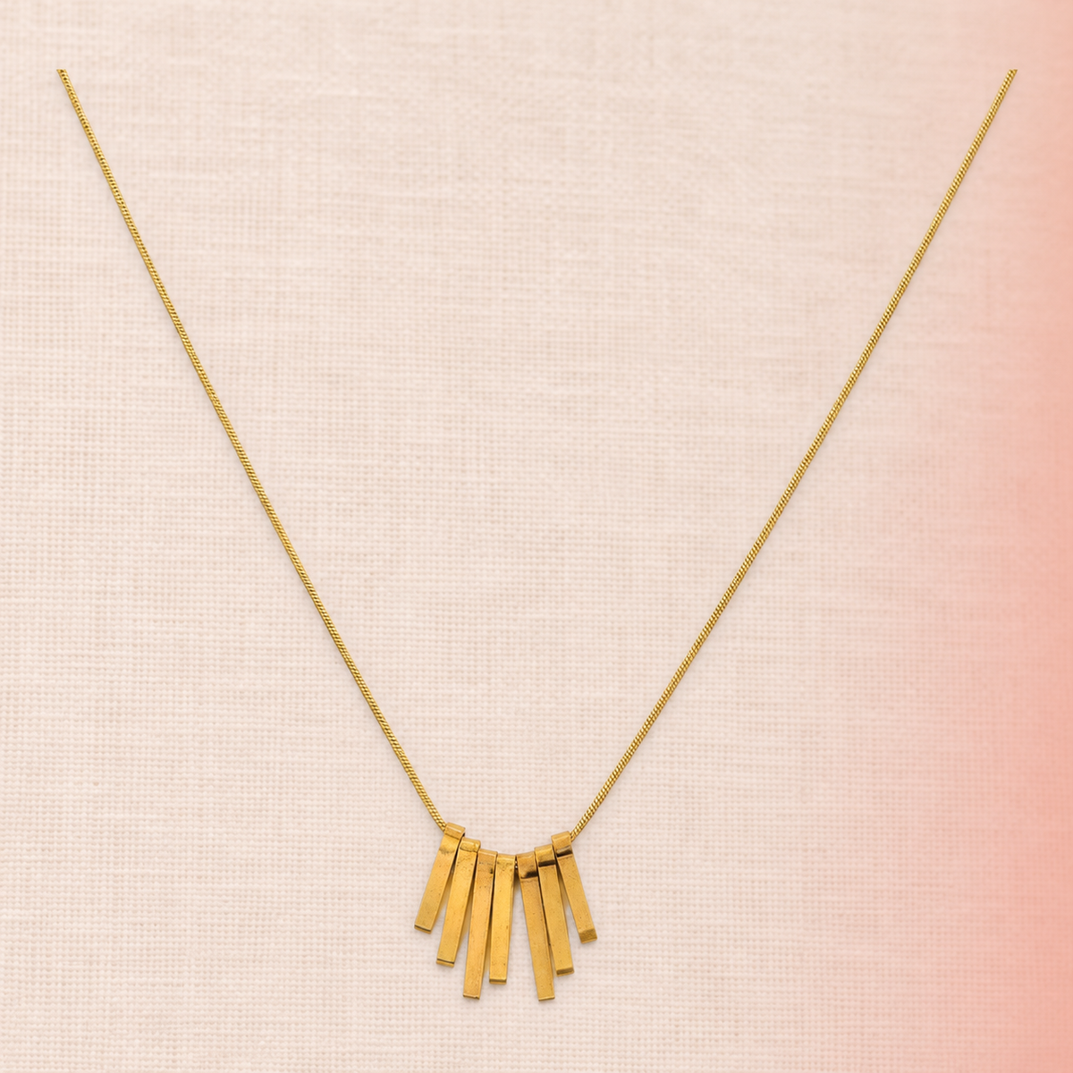 Gold-tone fine-chain necklace with seven graduated rectangular drops