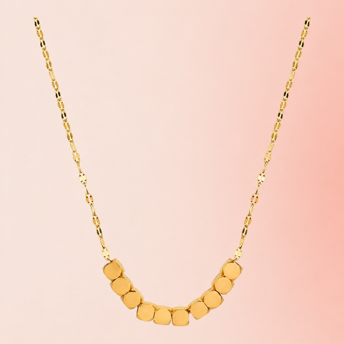 Gold-tone necklace with ten rounded-square beads at the front