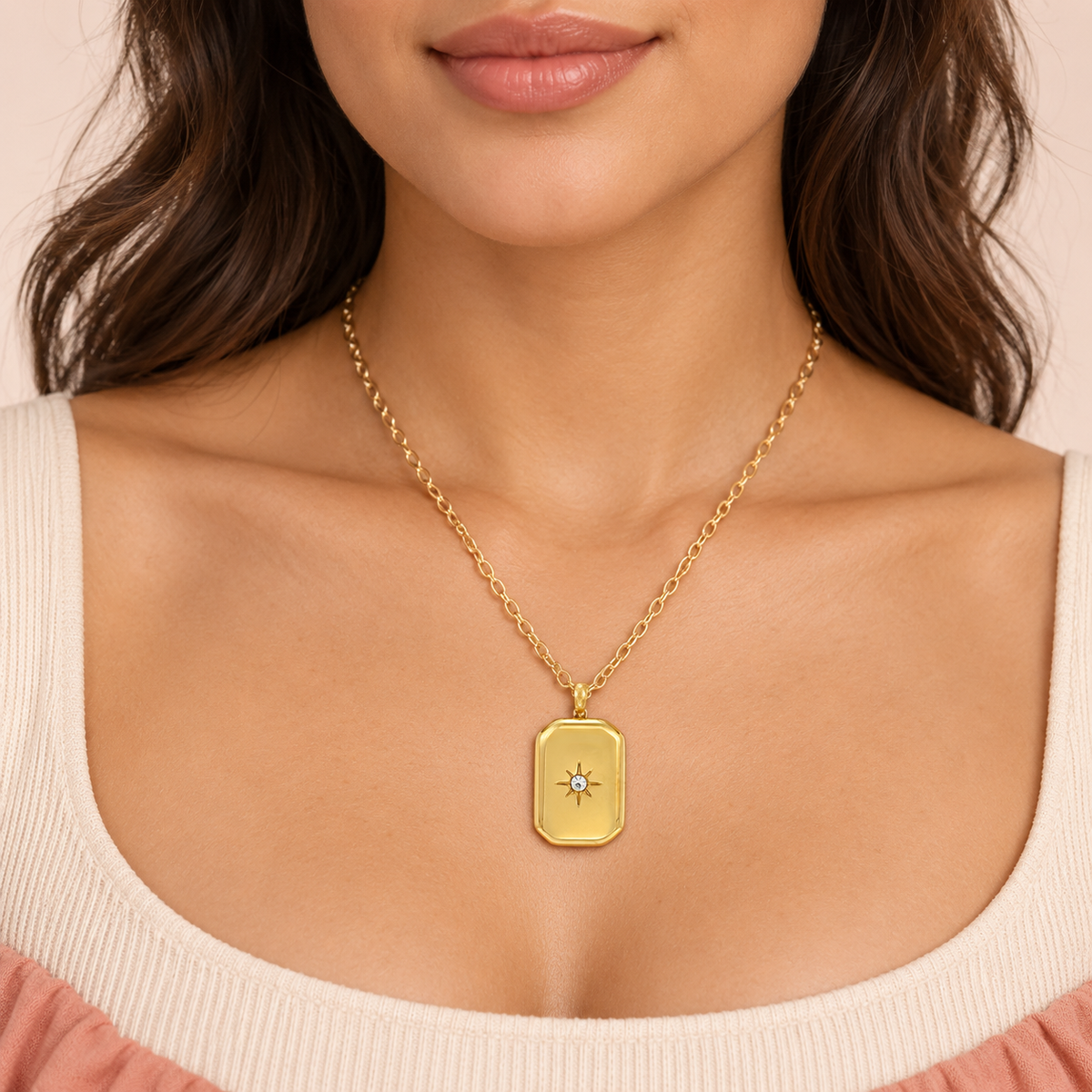 Gold-tone rectangular pendant necklace with a central star-shaped accent