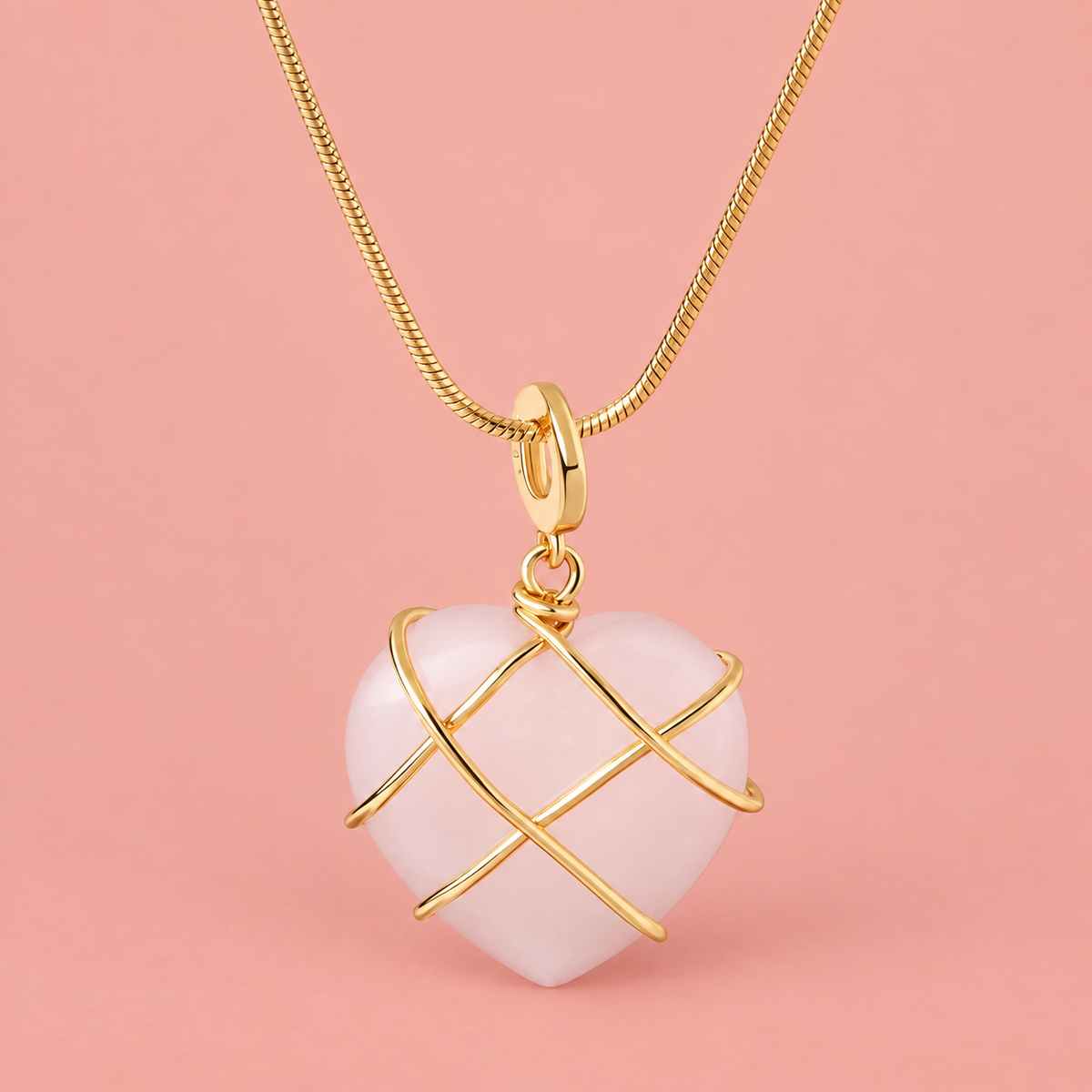 Pale-pink heart pendant necklace with crossing gold-tone bands