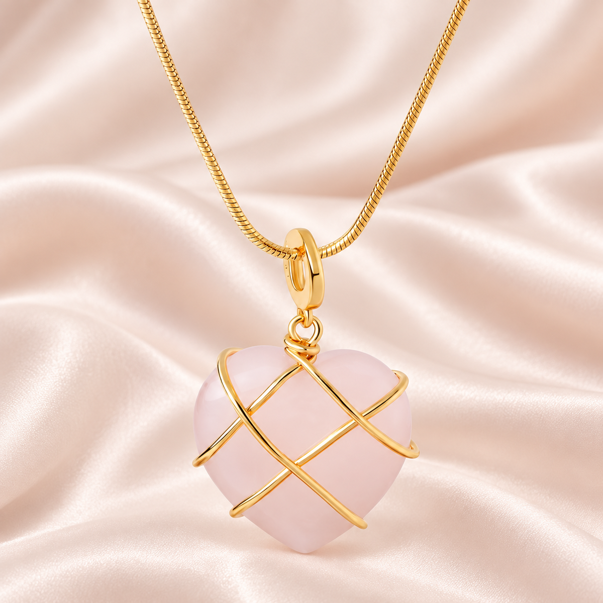 Pale-pink heart pendant necklace with crossing gold-tone bands