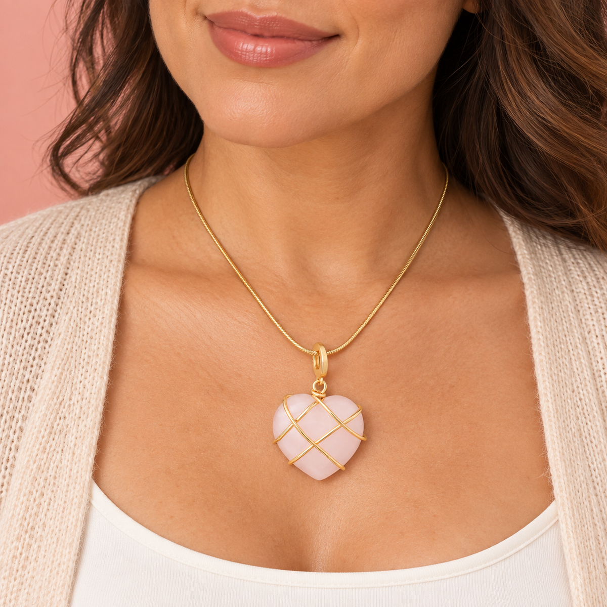 Pale-pink heart pendant necklace with crossing gold-tone bands