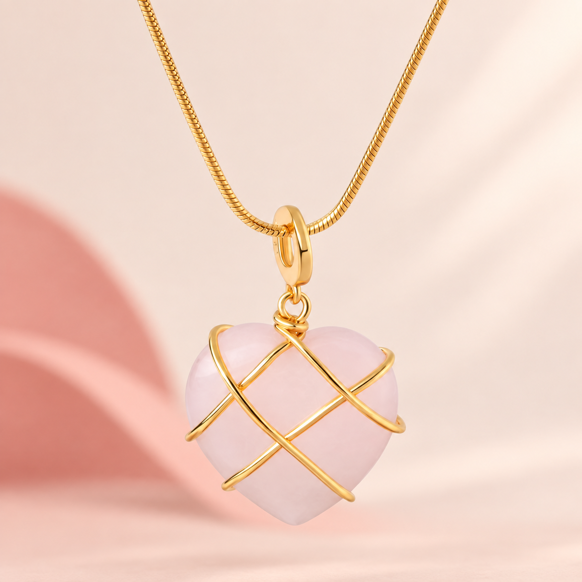 Pale-pink heart pendant necklace with crossing gold-tone bands