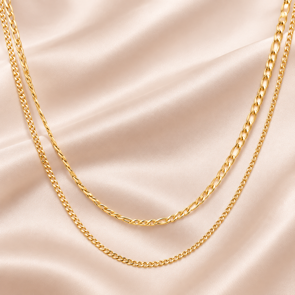 Gold-tone necklace shown with two chain layers of different link sizes