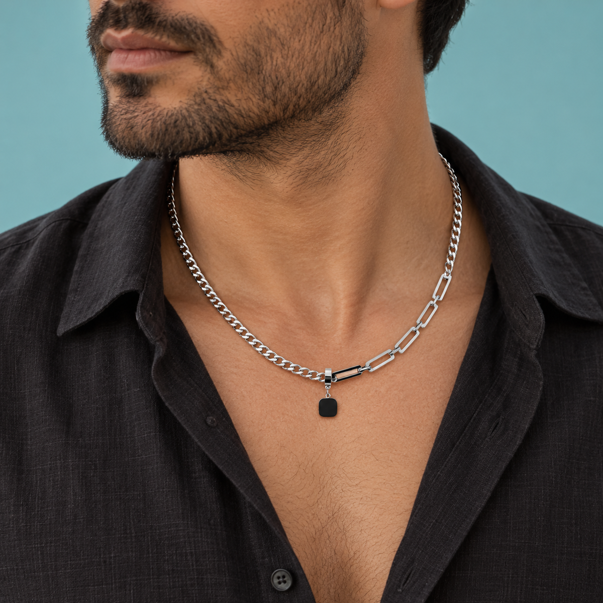 Angled styling view of the black pendant and asymmetric link necklace