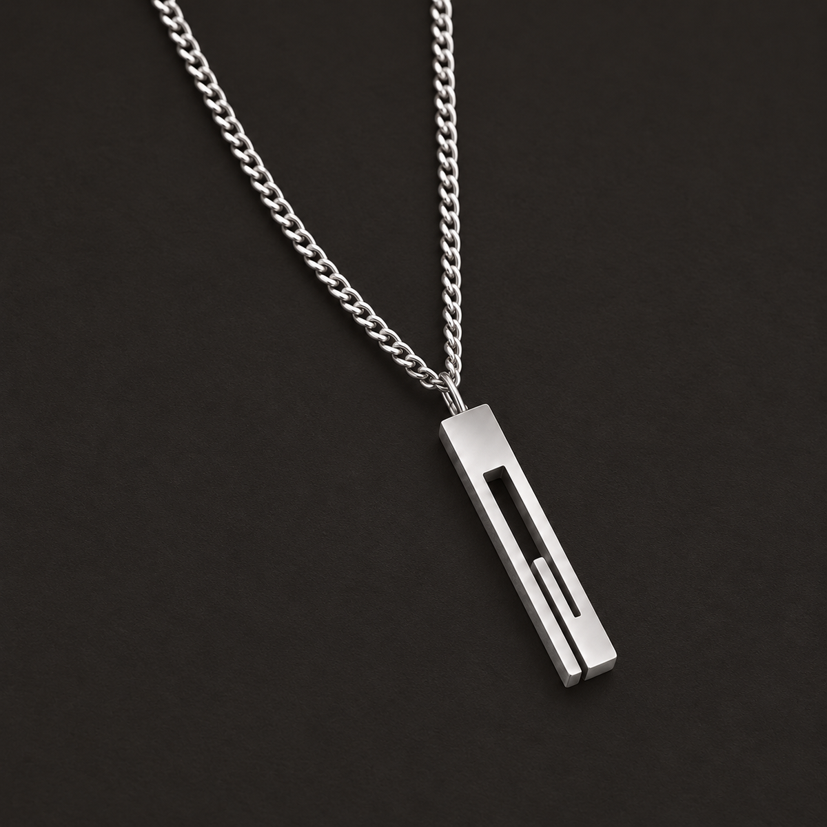 Silver-tone necklace with a long rectangular open-slot pendant