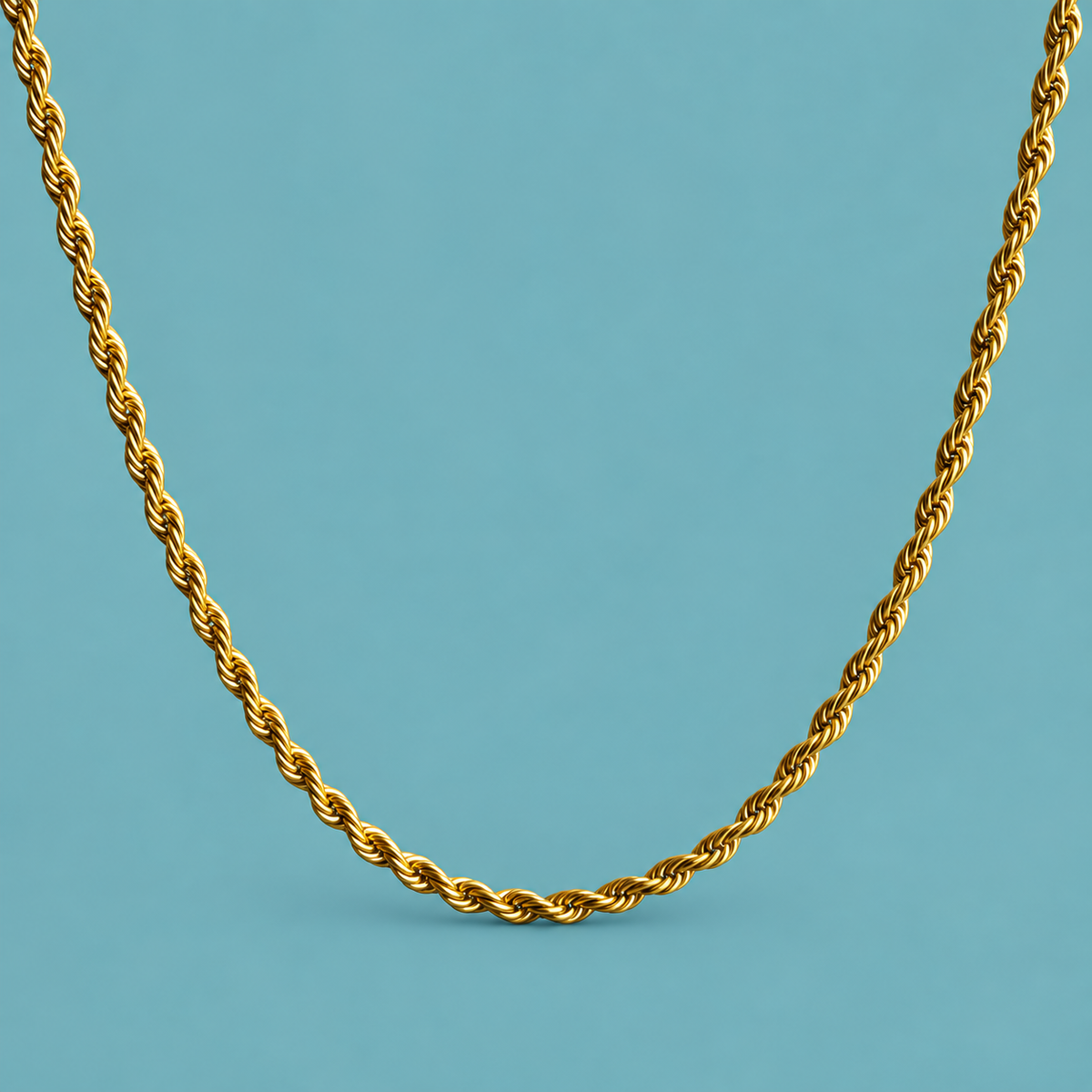 Gold-tone rope-style necklace on an aqua background