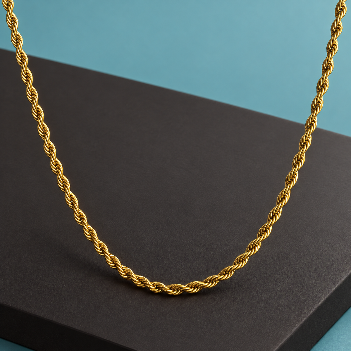 Rope-style necklace arranged across an aqua and charcoal display