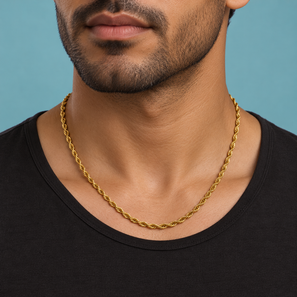 Gold-tone rope-style necklace shown with a black shirt