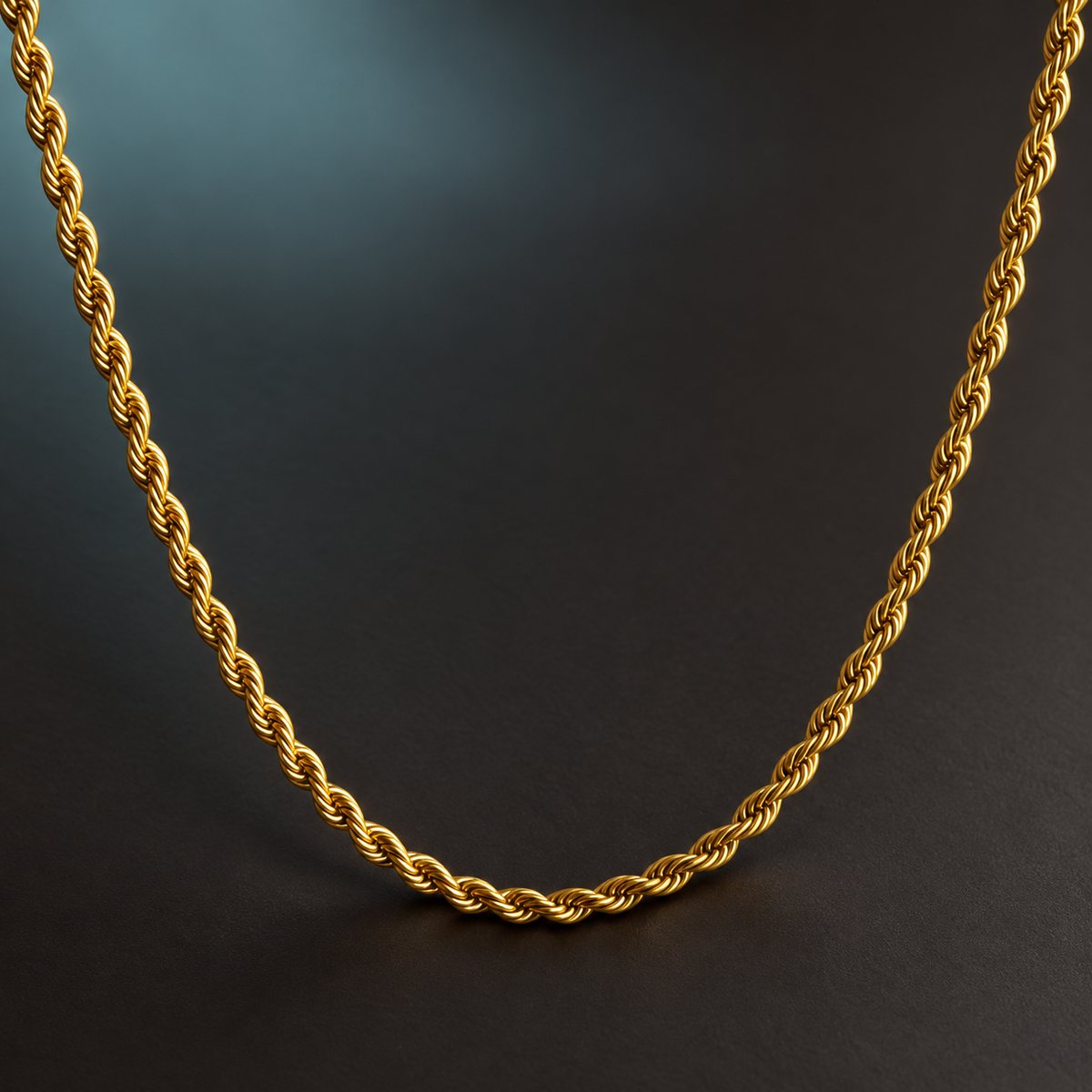 Gold-tone twisted necklace detail on charcoal