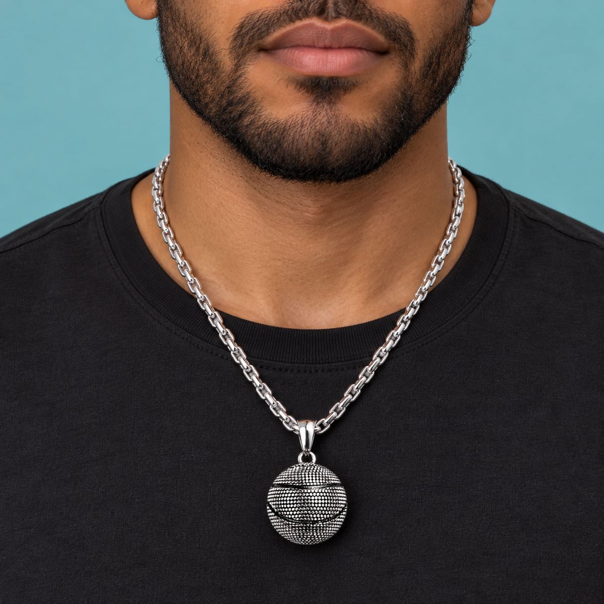 Textured ball pendant necklace styled over a black shirt