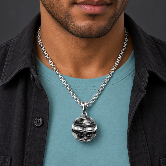 Textured ball pendant necklace worn with an aqua shirt and black jacket
