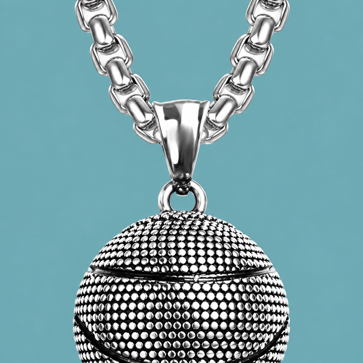 Close-up of the necklace's tapered bail and alternating chain links