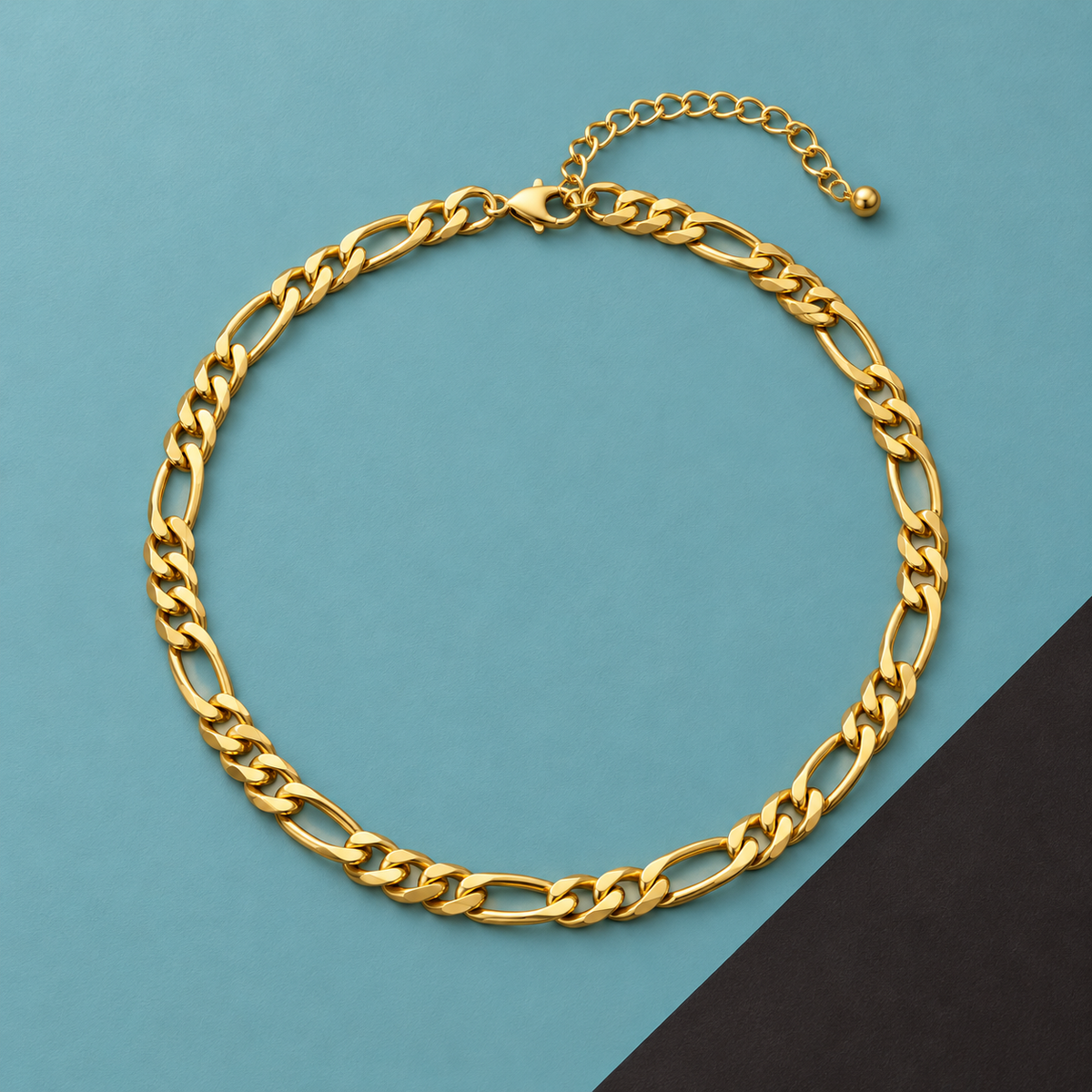 Bold Gold-Tone Figaro Necklace for Men on a teal and dark background