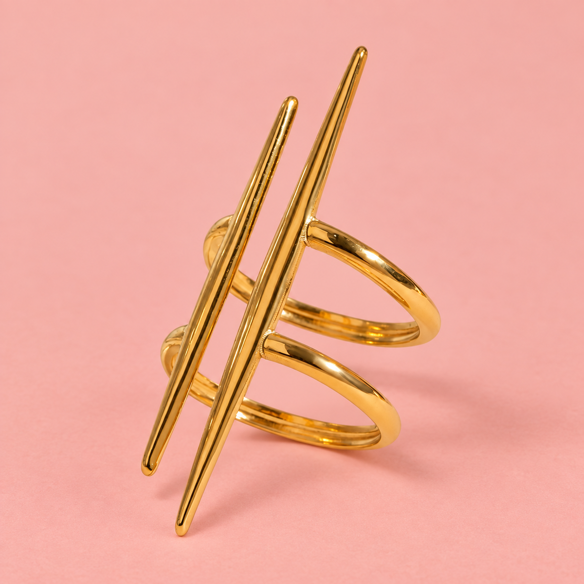 Gold-Tone Double Spike Ring on a pink background