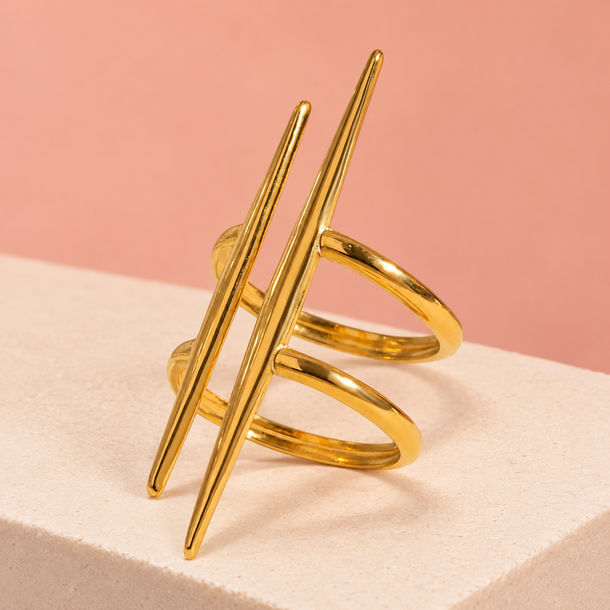 Gold-Tone Double Spike Ring on a display plinth