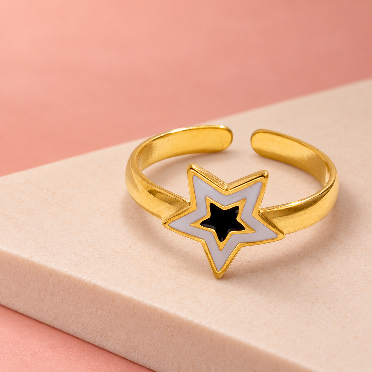 Nested-star ring arranged on a pale display block