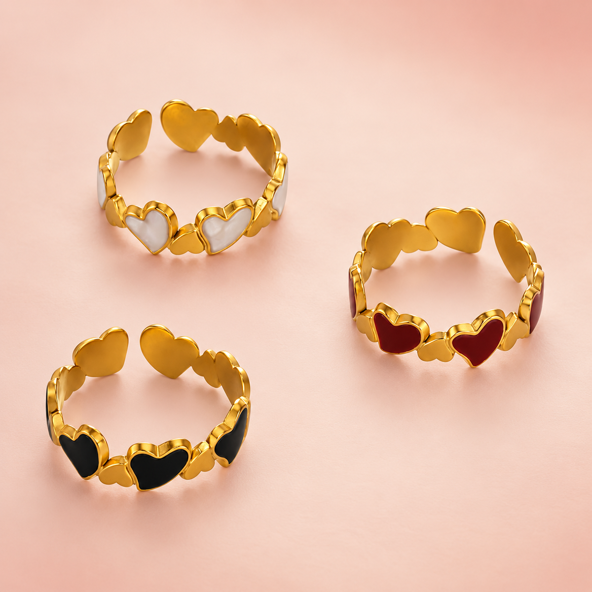 Three heart-link ring colourways shown together