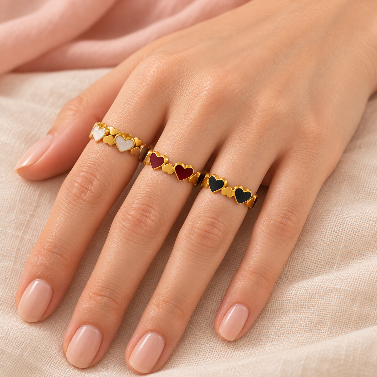 Three heart-link ring colourways shown together