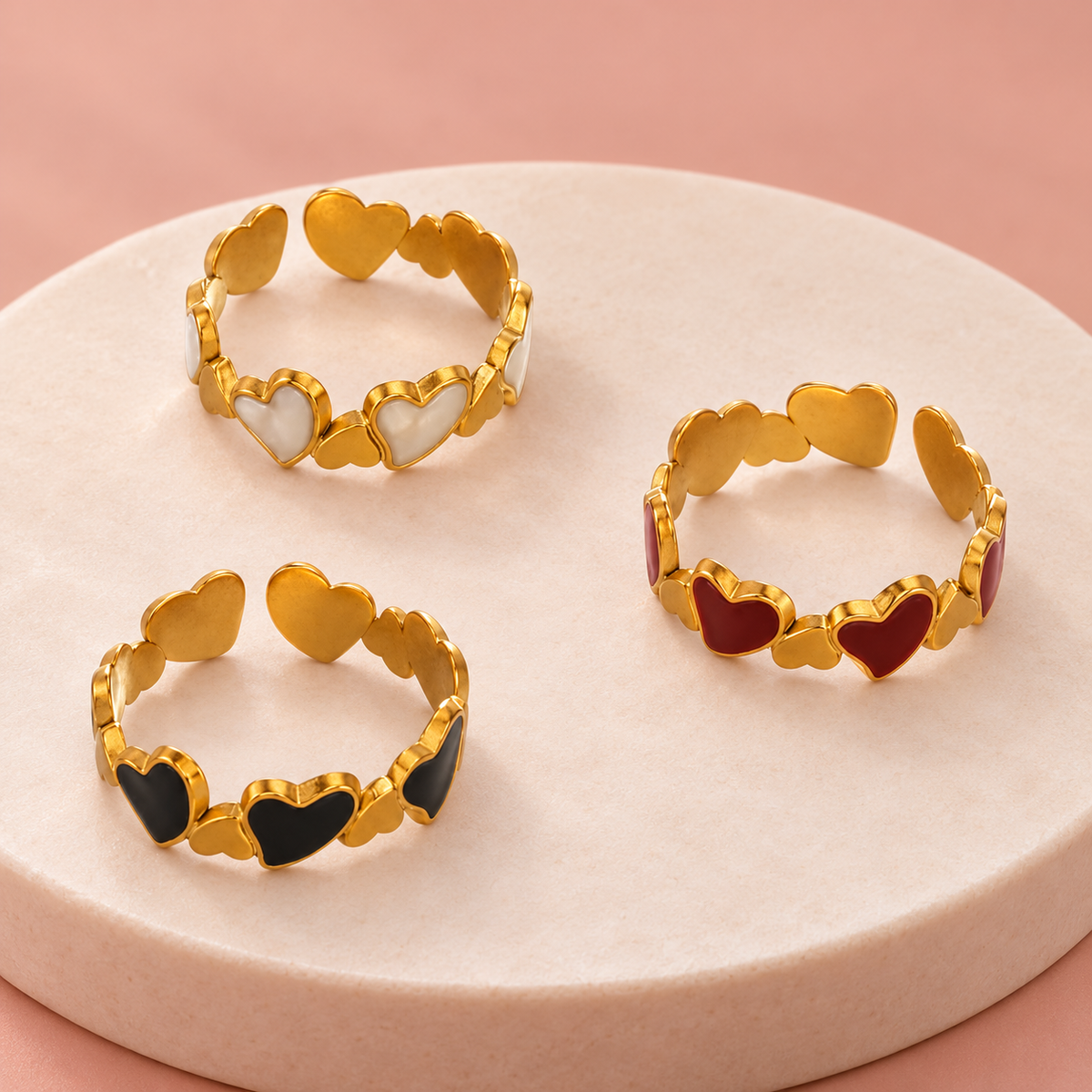 Three heart-link ring colourways shown together