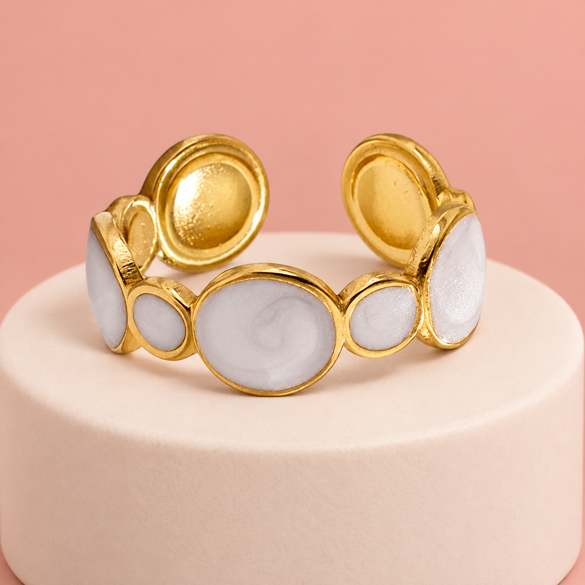 Circular-motif ring on a pale display plinth