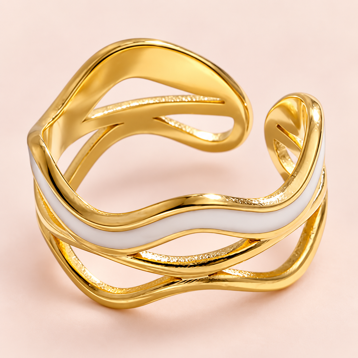 Close-up of the ring's pale wave and gold-tone openwork