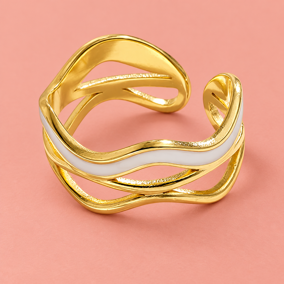 Pale wave open-back ring on a blush background