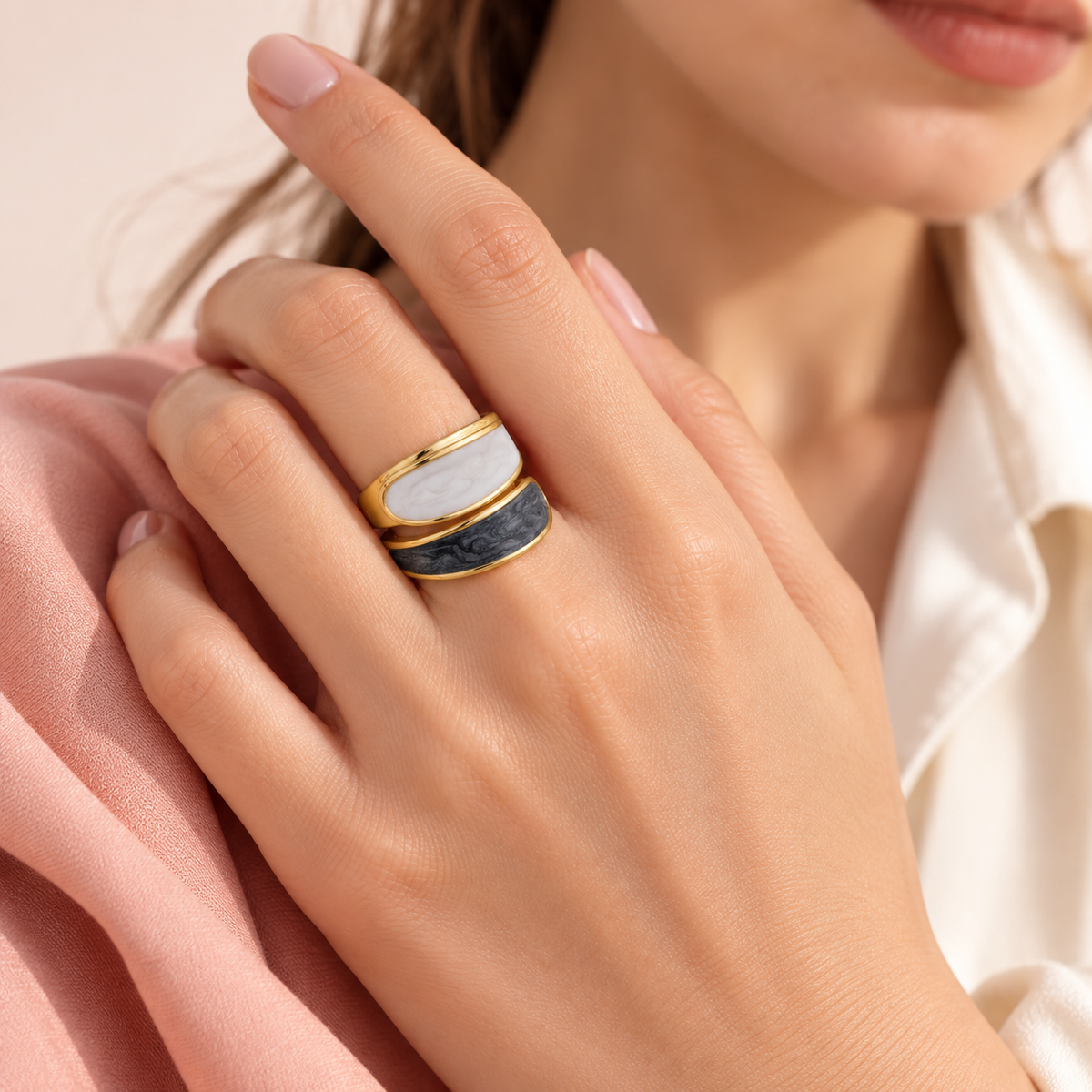 Two-tone curved-panel ring shown in a hand styling portrait