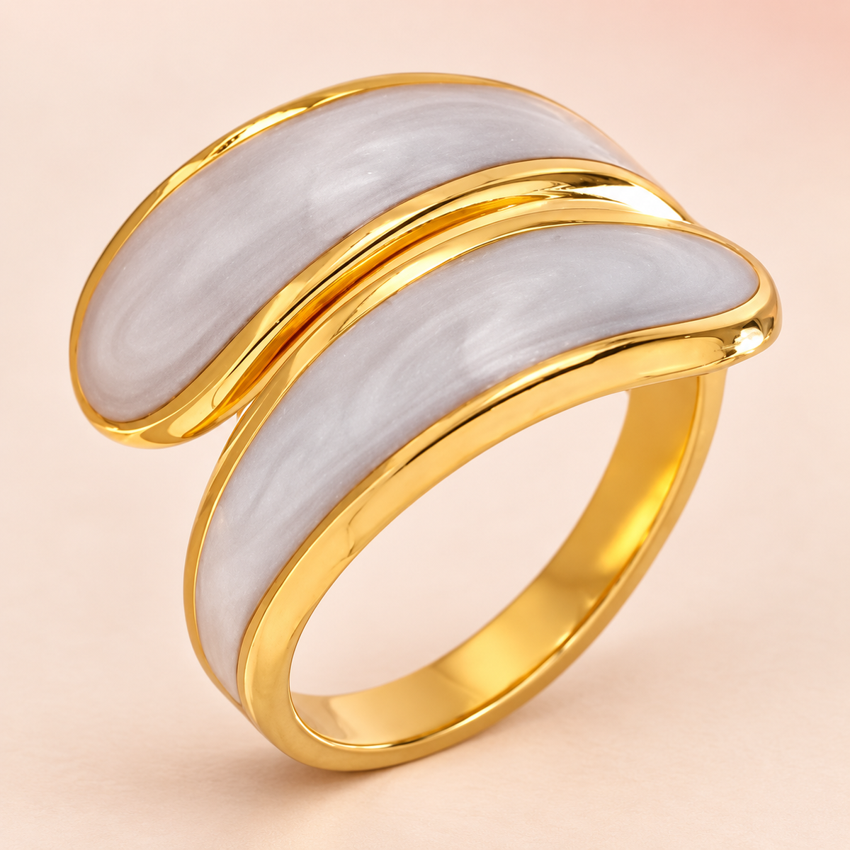 Gold-tone ring with two curved pale gray panels