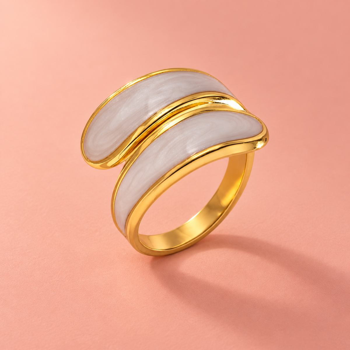 Curved pale-panel ring on a blush background