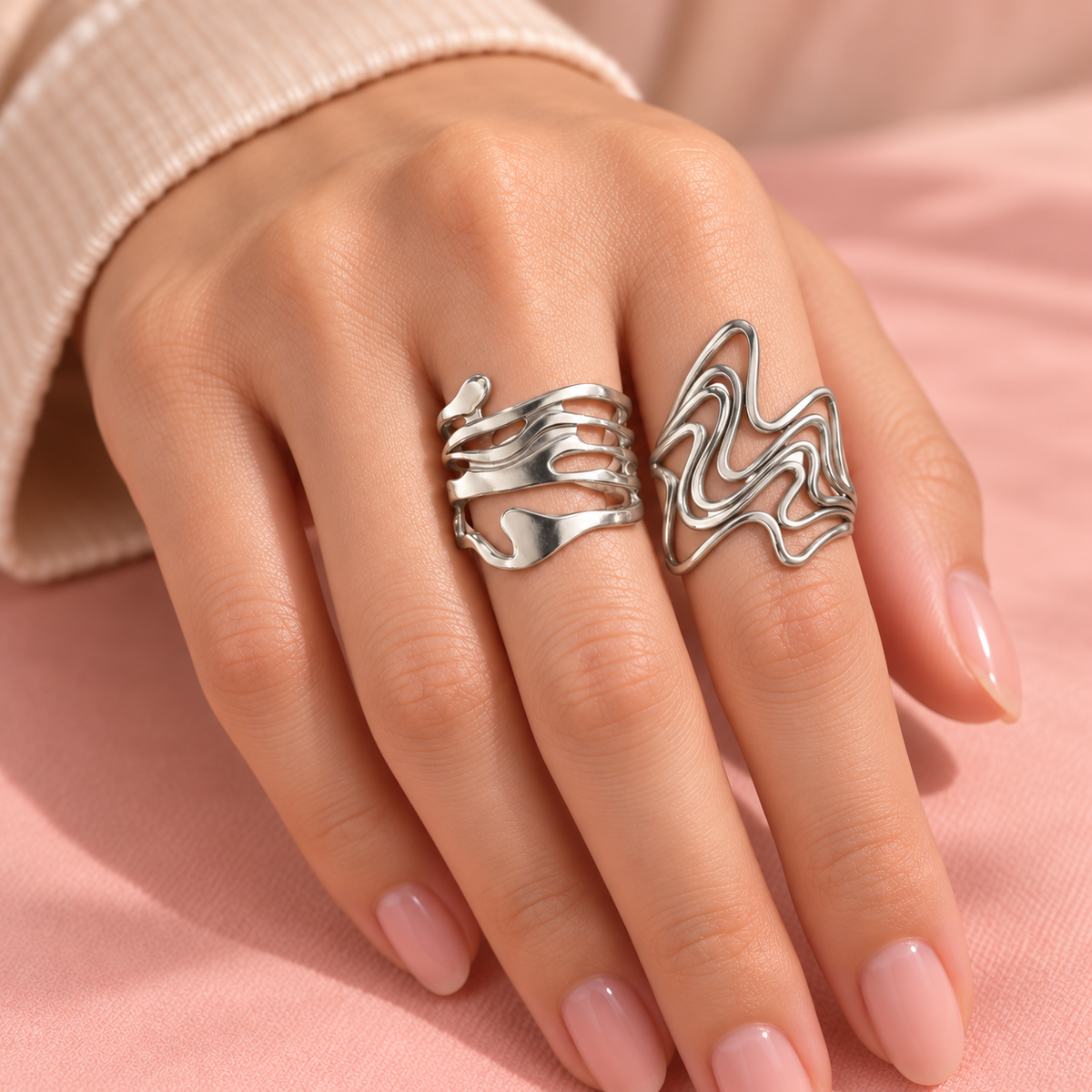 Silver-Tone Sculptural Ring Designs sculptural designs worn on a hand
