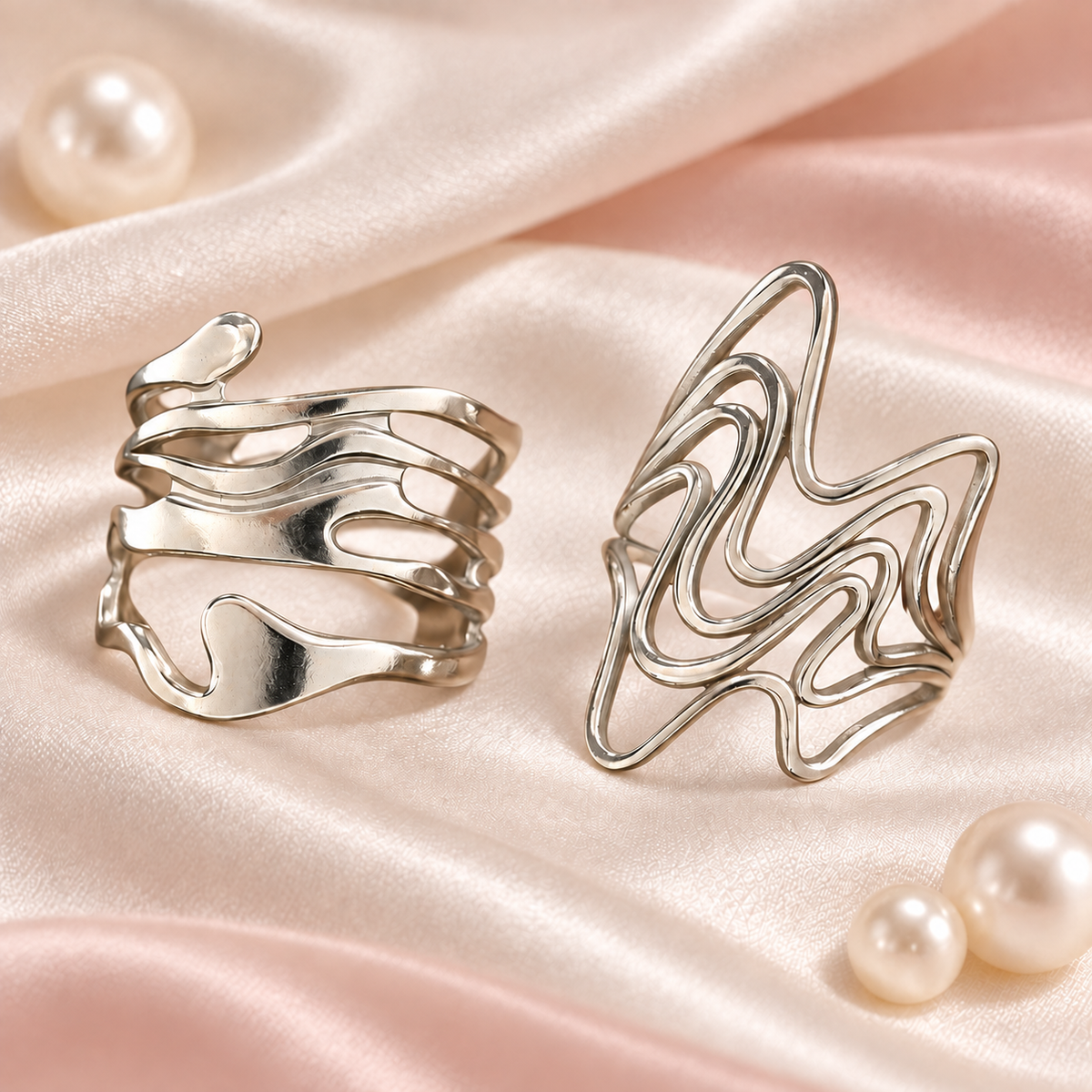 Silver-Tone Sculptural Ring Designs sculptural designs on satin