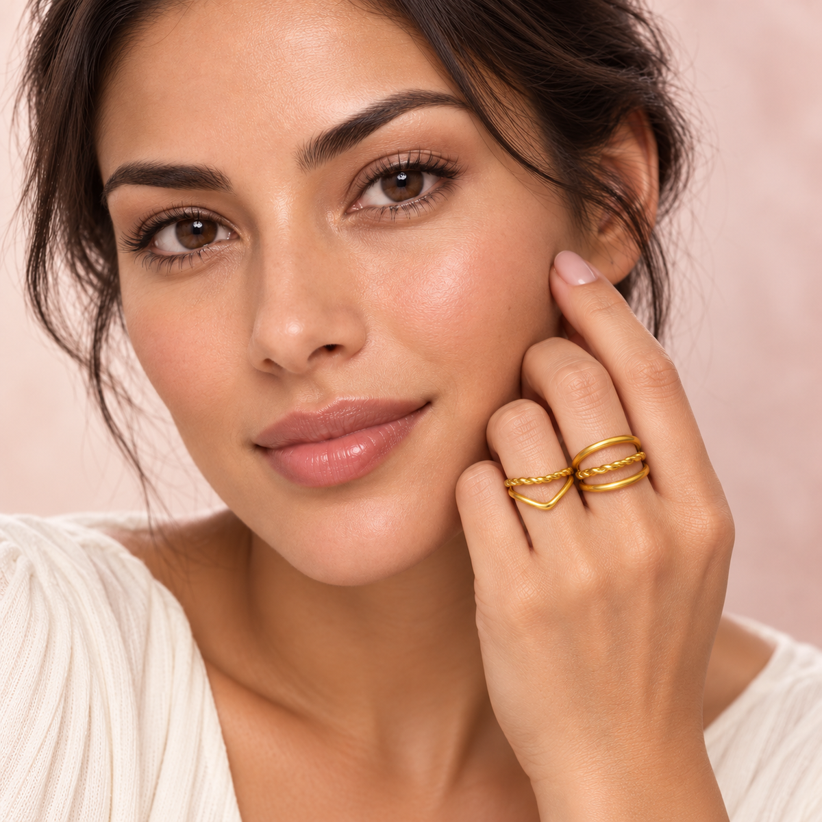 Gold-Tone Layered Ring Designs worn on a hand